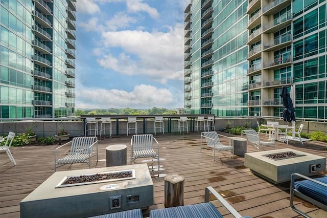 943 Peachtree St NE Unit 1518, Atlanta, GA 30309 - wooden deck with a fire pit and an outdoor bar
