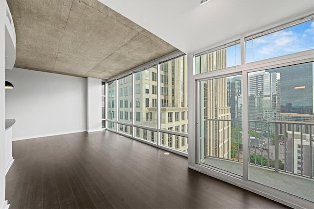 943 Peachtree St NE Unit 1518, Atlanta, GA 30309 - empty room featuring wood finished floors, a wall of windows, and baseboards