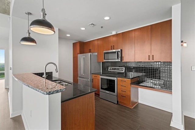 943 Peachtree St NE Unit 1518, Atlanta, GA 30309 - kitchen with appliances with stainless steel finishes, a sink, brown cabinetry, backsplash, and dark wood-style flooring
