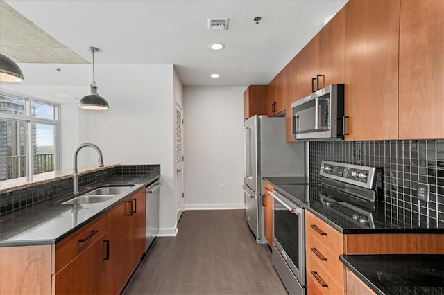 943 Peachtree St NE Unit 1518, Atlanta, GA 30309 - kitchen with appliances with stainless steel finishes, a sink, dark wood-type flooring, backsplash, and baseboards