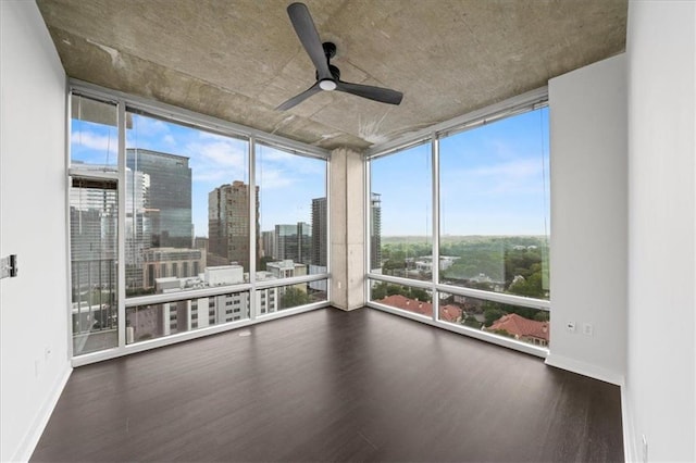 943 Peachtree St NE Unit 1518, Atlanta, GA 30309 - unfurnished sunroom with expansive windows, wood finished floors, baseboards, and a view of skyline