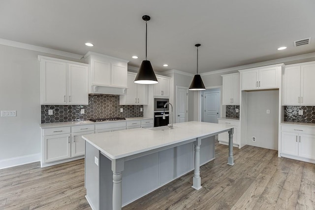 kitchen featuring backsplash, a sink, appliances with stainless steel finishes, white cabinetry, and recessed lighting