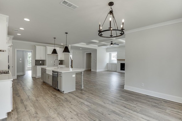kitchen featuring ornamental molding, a sink, open floor plan, recessed lighting, and stainless steel appliances