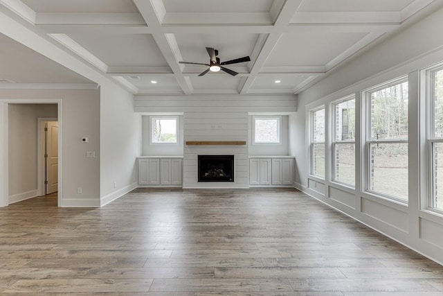 unfurnished living room with a ceiling fan, wood finished floors, beamed ceiling, a fireplace, and recessed lighting
