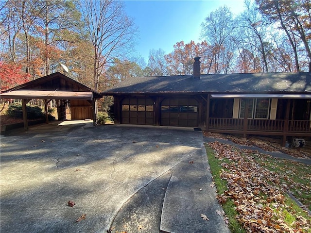 view of front of home featuring covered porch, a garage, and a carport