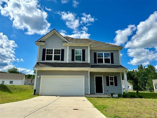 view of front of house with a garage and a front lawn