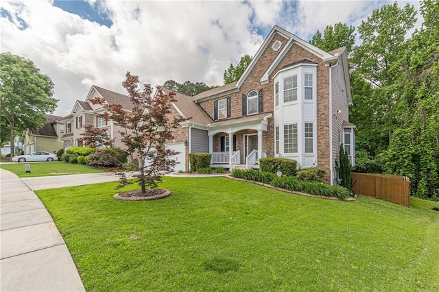 5342 Lakerock Dr SW, Atlanta, GA 30331 - traditional-style home featuring driveway, a garage, a porch, and brick siding