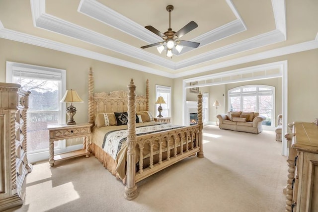 2740 Heritage Bend Ct SW, Grayson, GA 30017 - bedroom with light carpet, a raised ceiling, ornamental molding, and ceiling fan