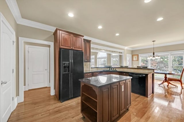 2740 Heritage Bend Ct SW, Grayson, GA 30017 - kitchen with black appliances, a sink, a kitchen island, open shelves, and light wood-style floors