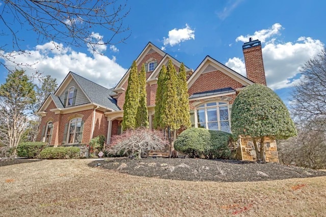 2740 Heritage Bend Ct SW, Grayson, GA 30017 - view of front of property with brick siding, a chimney, a front lawn, and stone siding