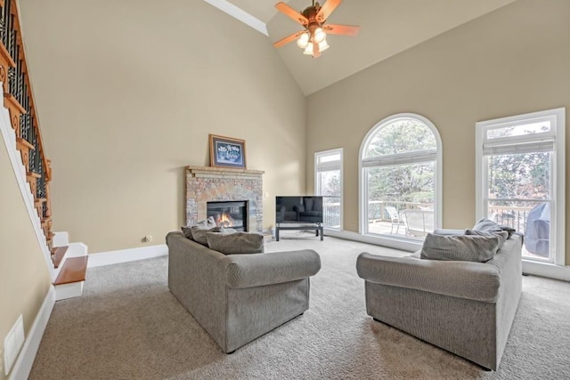 2740 Heritage Bend Ct SW, Grayson, GA 30017 - carpeted living area with high vaulted ceiling, a stone fireplace, a ceiling fan, and baseboards