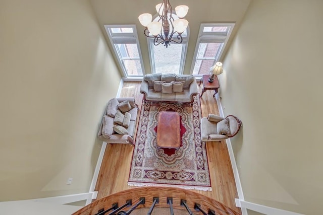 2740 Heritage Bend Ct SW, Grayson, GA 30017 - living room with a chandelier, wood finished floors, and baseboards
