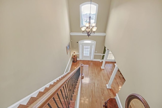 2740 Heritage Bend Ct SW, Grayson, GA 30017 - entryway featuring a chandelier, stairway, wood finished floors, a towering ceiling, and baseboards