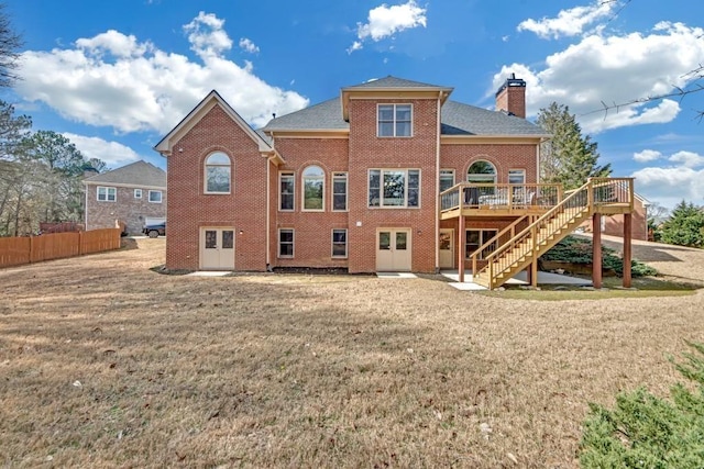 2740 Heritage Bend Ct SW, Grayson, GA 30017 - back of house with stairway, a chimney, a deck, brick siding, and roof with shingles