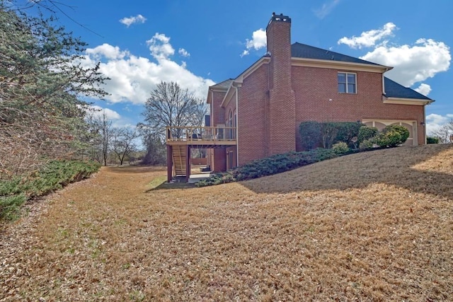 2740 Heritage Bend Ct SW, Grayson, GA 30017 - view of side of home with brick siding, a chimney, a deck, a lawn, and stairs