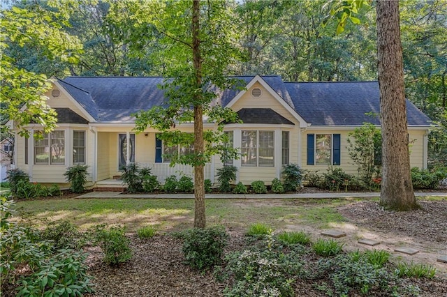 single story home with a shingled roof