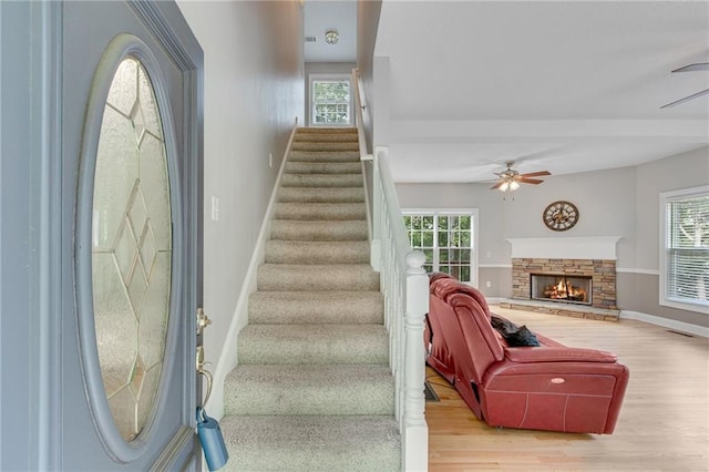 4039 Sargent Cir, Gainesville, GA 30506 - staircase with a ceiling fan, wood finished floors, baseboards, and a stone fireplace