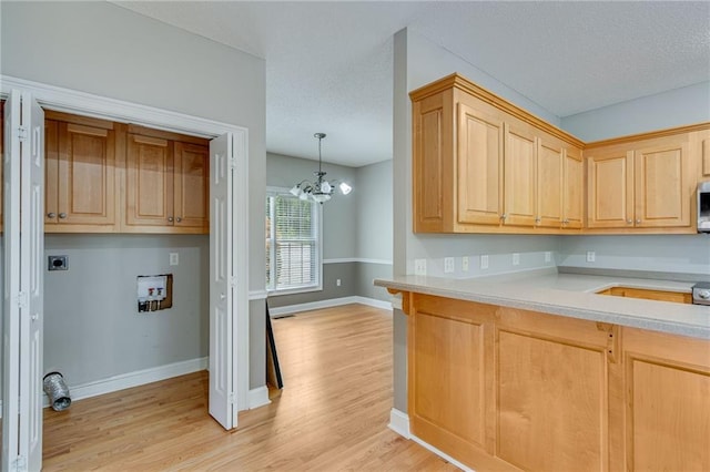 4039 Sargent Cir, Gainesville, GA 30506 - kitchen with light countertops, light wood finished floors, baseboards, a textured ceiling, and light brown cabinets