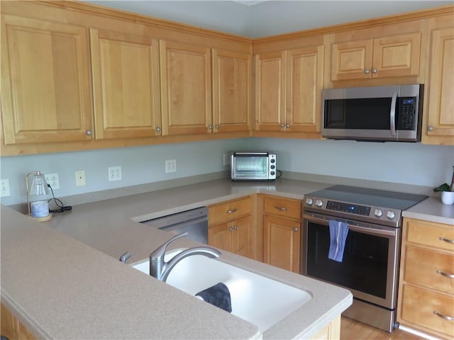 4039 Sargent Cir, Gainesville, GA 30506 - kitchen featuring appliances with stainless steel finishes, a sink, light countertops, and light brown cabinets