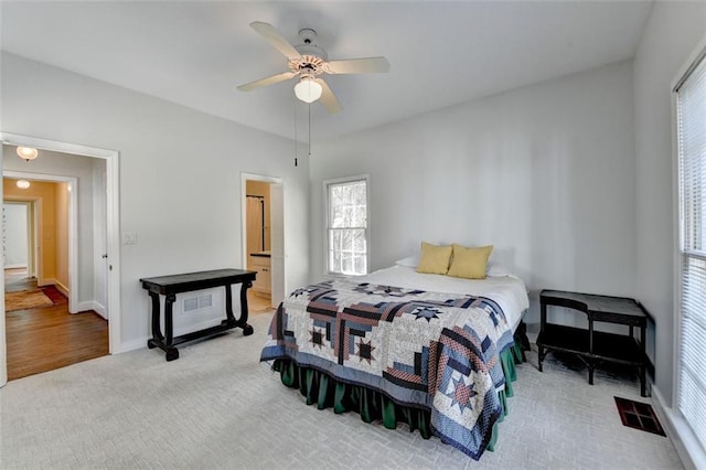 bedroom featuring visible vents, baseboards, carpet floors, and ceiling fan