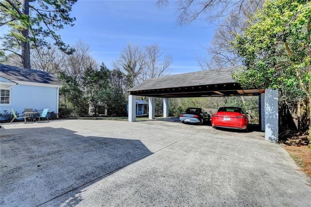 view of parking / parking lot with a carport and driveway