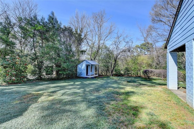 view of yard with a storage shed and an outbuilding