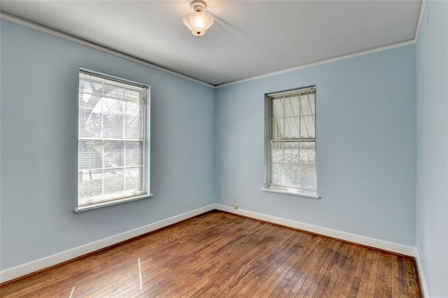 unfurnished room featuring hardwood / wood-style floors, baseboards, and ornamental molding