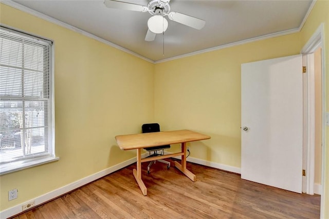 office area with a wealth of natural light, baseboards, light wood-style flooring, and crown molding