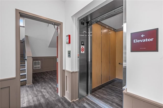 388 Pratt Dr Unit 2113, Atlanta, GA 30315 - corridor featuring elevator, dark wood finished floors, and a wainscoted wall