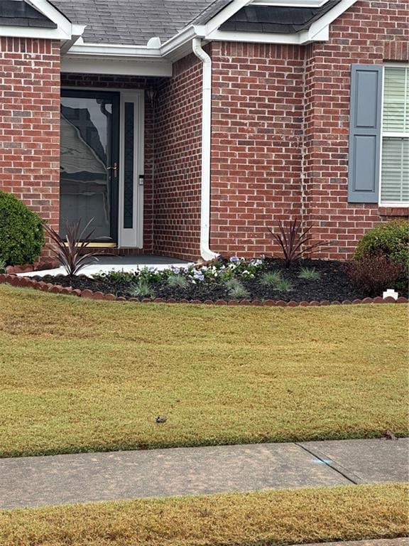 entrance to property with a yard