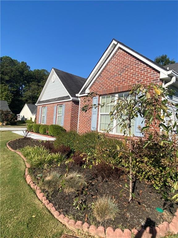 view of side of home featuring a yard