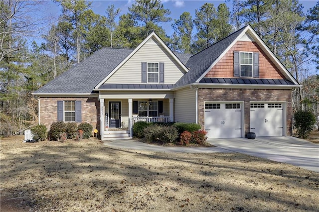 craftsman inspired home featuring a porch and a garage