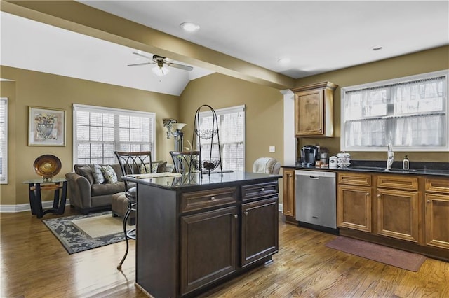 kitchen with ceiling fan, dishwasher, vaulted ceiling with beams, wood-type flooring, and a kitchen island