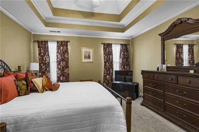 carpeted bedroom featuring a raised ceiling, multiple windows, and ornamental molding