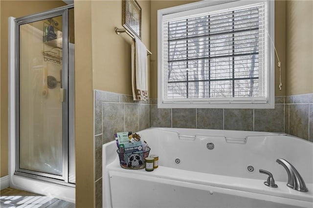 bathroom featuring shower with separate bathtub