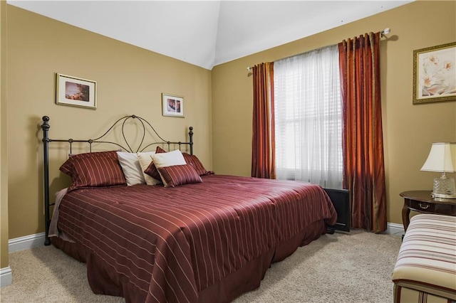 carpeted bedroom featuring lofted ceiling