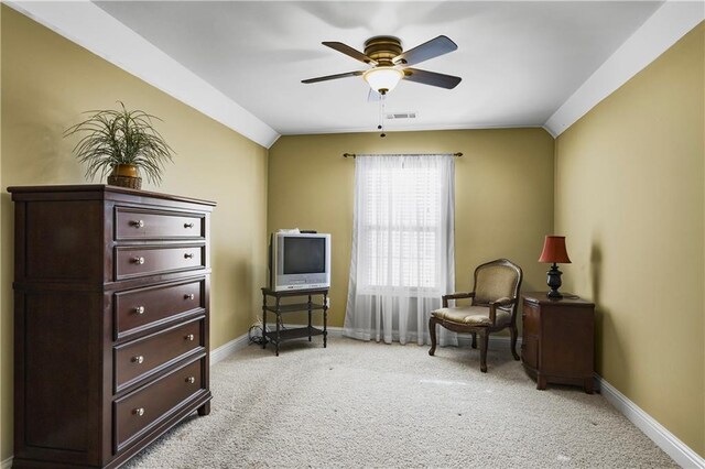 living area featuring light carpet, vaulted ceiling, and ceiling fan