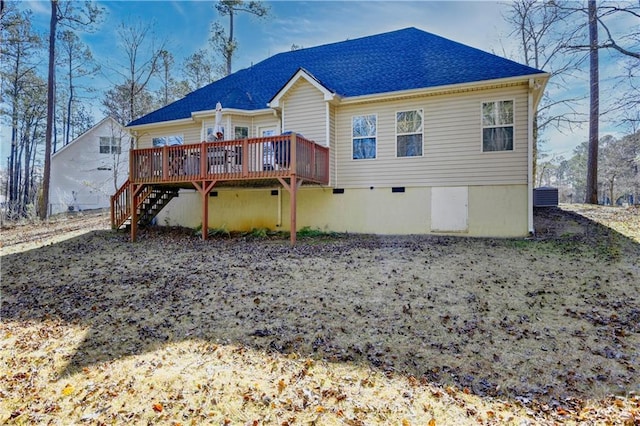 rear view of property featuring a wooden deck