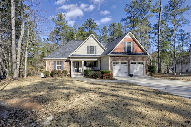 view of front of home featuring covered porch and a garage