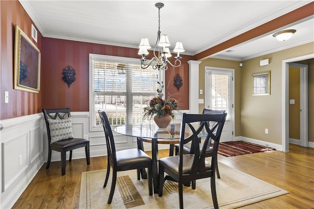 dining room with crown molding, a chandelier, and dark hardwood / wood-style floors