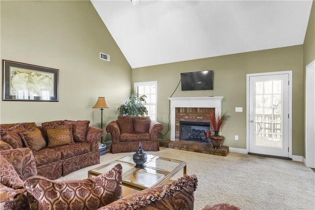 living room featuring plenty of natural light, carpet floors, a fireplace, and high vaulted ceiling