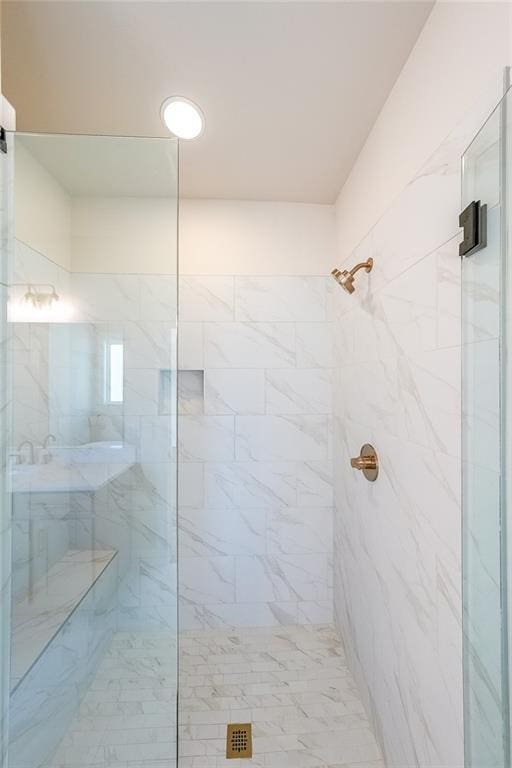 full bath with a marble finish shower