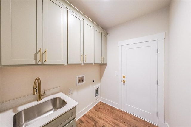 clothes washing area featuring washer hookup, light wood finished floors, cabinet space, a sink, and electric dryer hookup