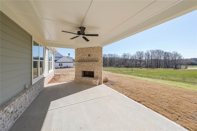 view of patio / terrace featuring an outdoor brick fireplace and a ceiling fan