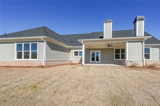 back of house featuring french doors, roof with shingles, a chimney, a patio area, and ceiling fan