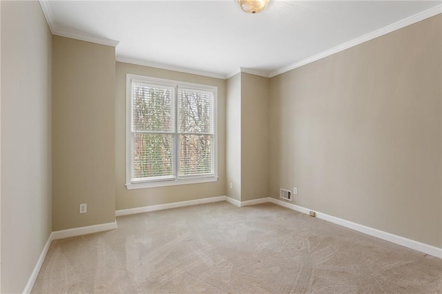 empty room featuring baseboards, carpet flooring, and crown molding