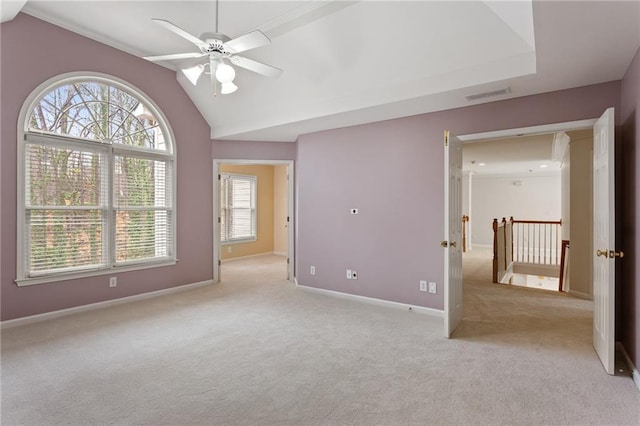 empty room with a ceiling fan, baseboards, visible vents, vaulted ceiling, and light colored carpet