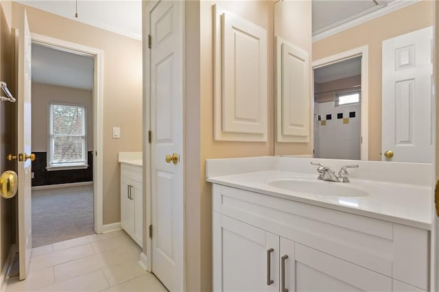 full bathroom featuring vanity, tile patterned floors, crown molding, and baseboards