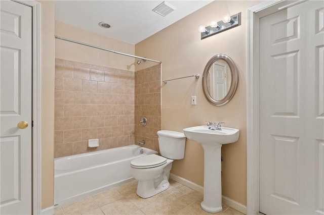 bathroom with tile patterned flooring, visible vents, baseboards, toilet, and  shower combination