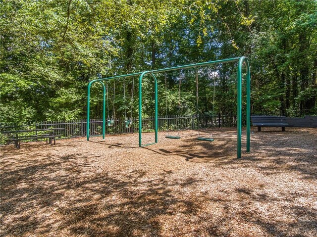 community jungle gym featuring fence